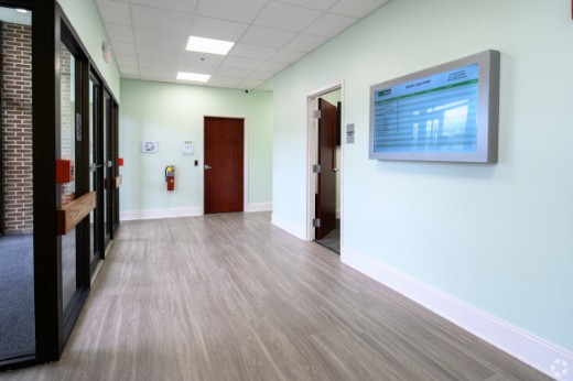 a hallway with a tv on the wall.	